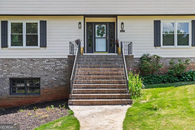 3441 Sherrod Dr SW, Marietta, GA 30060 - view of exterior entry featuring brick siding and a lawn