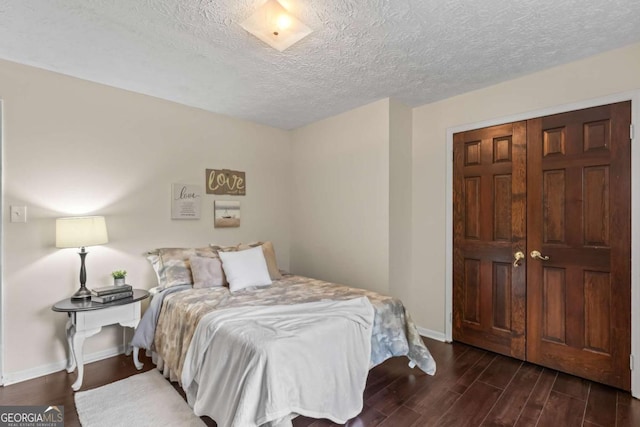 3441 Sherrod Dr SW, Marietta, GA 30060 - bedroom with dark wood-type flooring, baseboards, and a textured ceiling