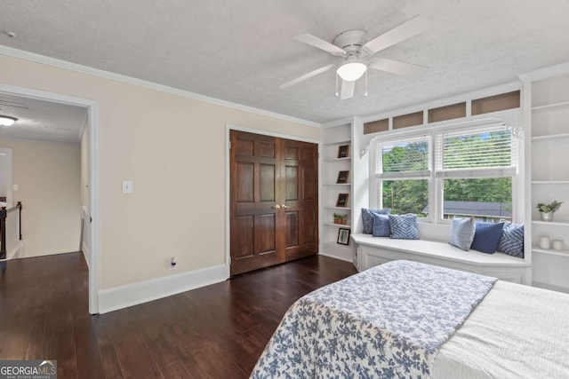3441 Sherrod Dr SW, Marietta, GA 30060 - bedroom with a textured ceiling, dark wood-style floors, baseboards, a closet, and ornamental molding