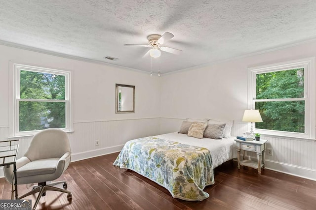 3441 Sherrod Dr SW, Marietta, GA 30060 - bedroom featuring wood-type flooring, baseboards, a textured ceiling, crown molding, and a wainscoted wall