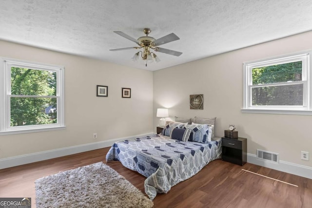 3441 Sherrod Dr SW, Marietta, GA 30060 - bedroom featuring multiple windows, wood finished floors, baseboards, a textured ceiling, and a ceiling fan