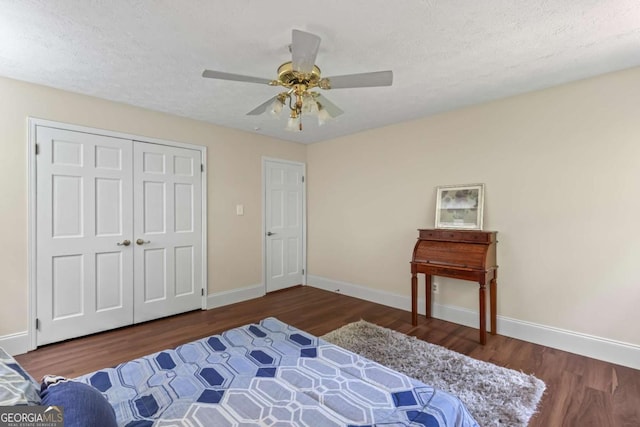 3441 Sherrod Dr SW, Marietta, GA 30060 - bedroom with wood finished floors, baseboards, a ceiling fan, a closet, and a textured ceiling