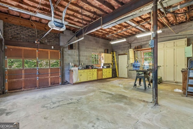 3441 Sherrod Dr SW, Marietta, GA 30060 - garage featuring a garage door opener and concrete block wall