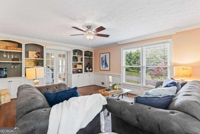 3441 Sherrod Dr SW, Marietta, GA 30060 - living area with dark wood finished floors, crown molding, ceiling fan, wainscoting, and built in shelves