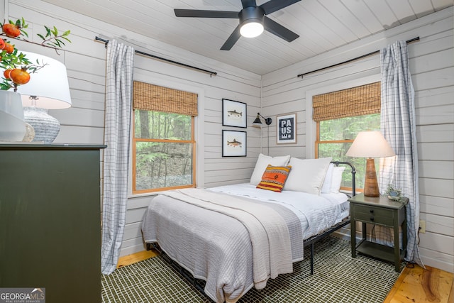 7 Ascherman Ct, Blue Ridge, GA 30513 - bedroom with multiple windows, wood walls, wood finished floors, and ceiling fan