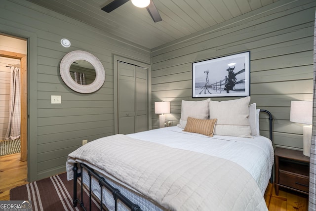 7 Ascherman Ct, Blue Ridge, GA 30513 - bedroom with wooden walls, wood finished floors, a closet, and a ceiling fan