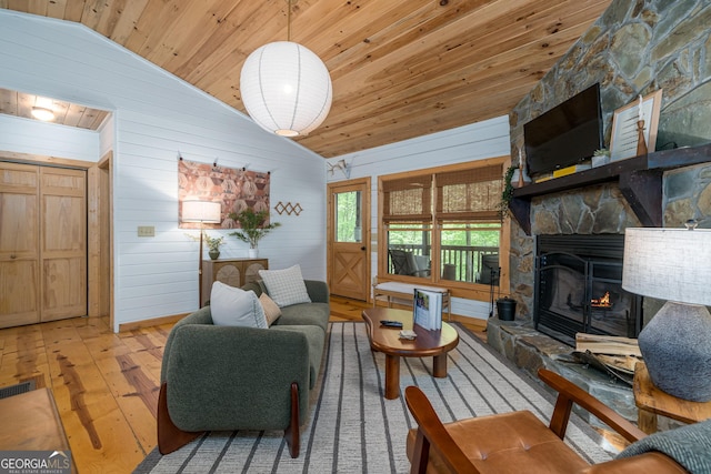 7 Ascherman Ct, Blue Ridge, GA 30513 - living room featuring vaulted ceiling, hardwood / wood-style floors, wood ceiling, a stone fireplace, and wooden walls