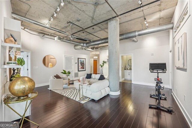 206 NE 11th St NE Unit Ph703, Atlanta, GA 30309 - living area featuring a towering ceiling, rail lighting, baseboards, and wood finished floors