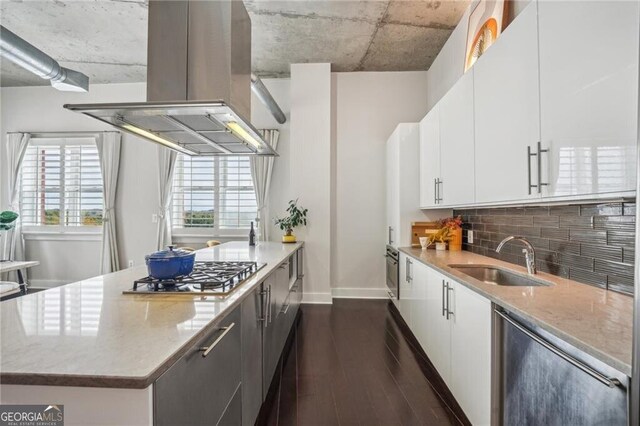 206 NE 11th St NE Unit Ph703, Atlanta, GA 30309 - kitchen with island exhaust hood, stainless steel gas stovetop, a sink, dark wood-type flooring, and tasteful backsplash