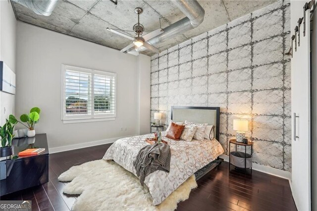 206 NE 11th St NE Unit Ph703, Atlanta, GA 30309 - bedroom featuring baseboards, wood finished floors, and an accent wall