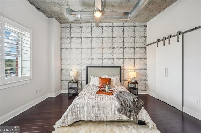 206 NE 11th St NE Unit Ph703, Atlanta, GA 30309 - bedroom featuring wood finished floors, baseboards, and an accent wall