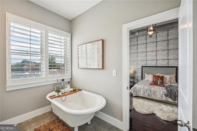 206 NE 11th St NE Unit Ph703, Atlanta, GA 30309 - ensuite bathroom with baseboards and a soaking tub