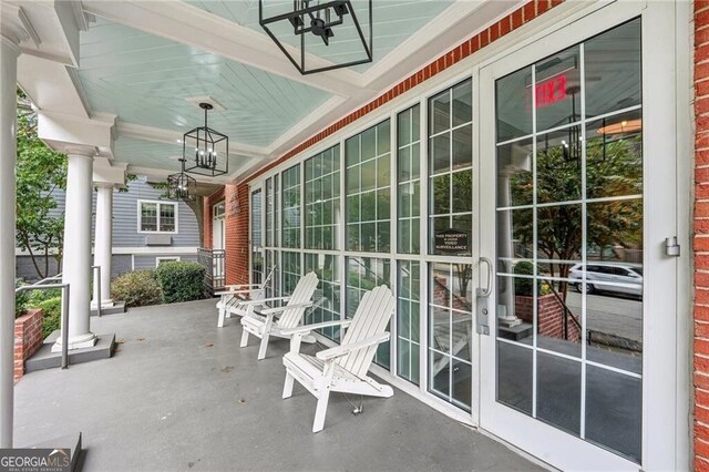 206 NE 11th St NE Unit Ph703, Atlanta, GA 30309 - unfurnished sunroom featuring a chandelier