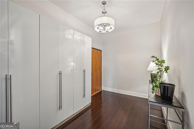 206 NE 11th St NE Unit Ph703, Atlanta, GA 30309 - corridor with dark wood-type flooring, baseboards, and a chandelier