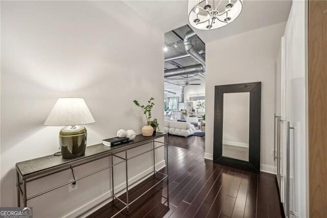 206 NE 11th St NE Unit Ph703, Atlanta, GA 30309 - hallway featuring dark wood-type flooring, a chandelier, and baseboards