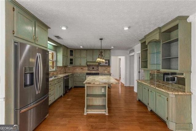 kitchen with open shelves, appliances with stainless steel finishes, green cabinets, dark wood-style flooring, and a textured ceiling