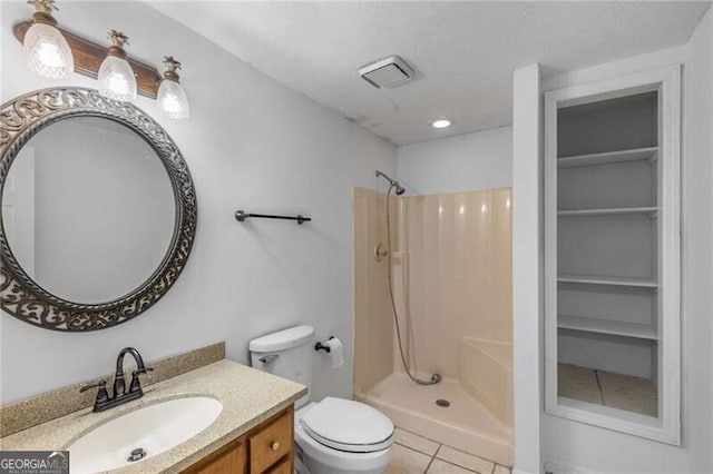 bathroom with a shower stall, tile patterned flooring, vanity, and toilet
