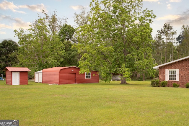 3842 Kay Cir, Blackshear, GA 31516 - view of grassy yard with an outdoor structure, a detached garage, and a shed