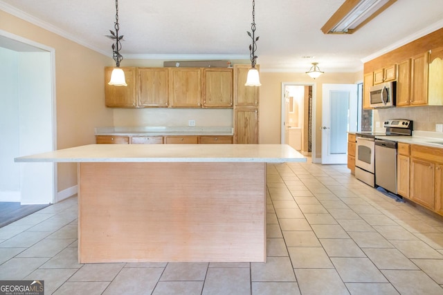 3842 Kay Cir, Blackshear, GA 31516 - kitchen featuring appliances with stainless steel finishes, ornamental molding, light tile patterned flooring, light countertops, and a kitchen island