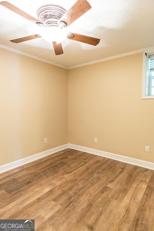 3842 Kay Cir, Blackshear, GA 31516 - spare room with wood finished floors, a ceiling fan, crown molding, a textured ceiling, and baseboards