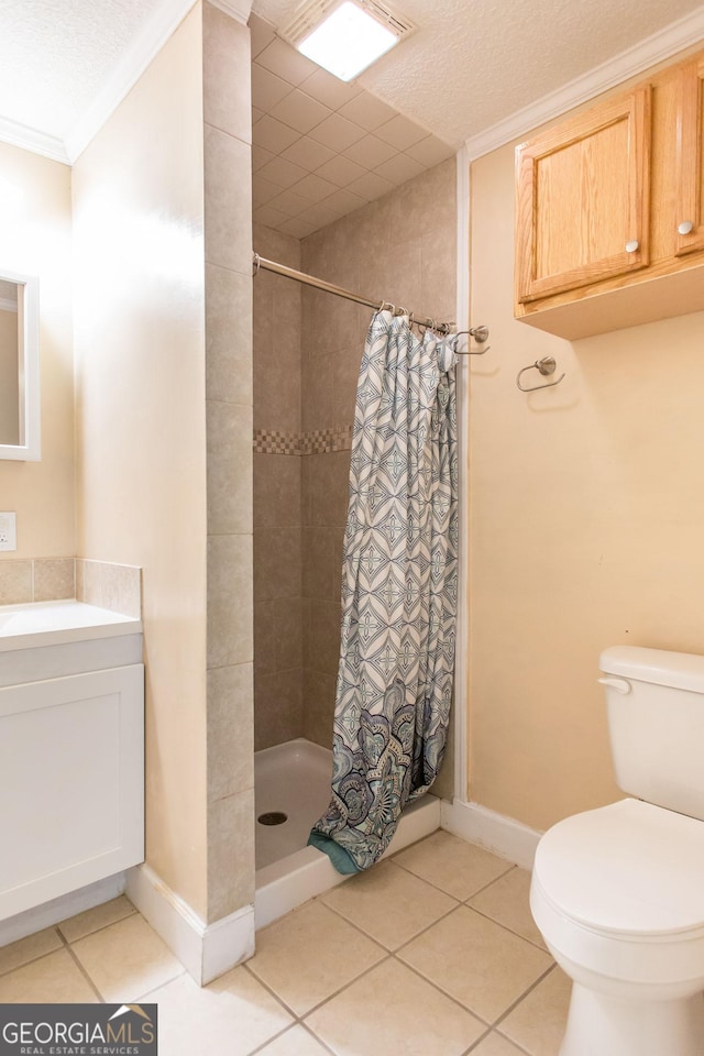 3842 Kay Cir, Blackshear, GA 31516 - bathroom featuring tiled shower, tile patterned floors, toilet, vanity, and crown molding
