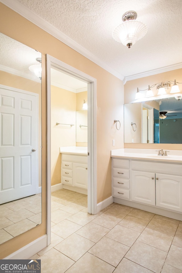 3842 Kay Cir, Blackshear, GA 31516 - bathroom featuring ornamental molding, a textured ceiling, vanity, tile patterned flooring, and baseboards