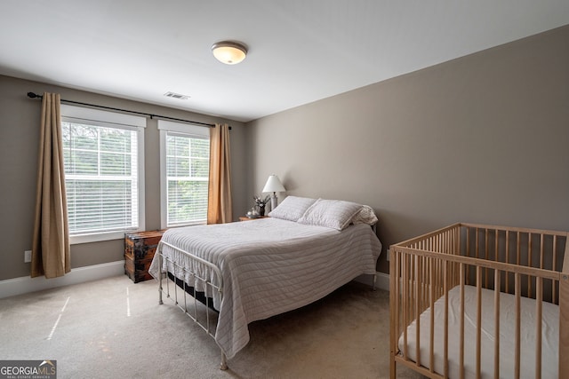 carpeted bedroom featuring baseboards