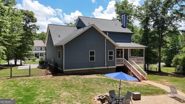 back of property with a chimney, stairway, a patio, and a shingled roof