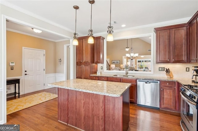 3365 Buffington Ln, Cumming, GA 30040 - kitchen featuring stainless steel appliances, a sink, a kitchen island, light stone counters, and dark wood-type flooring
