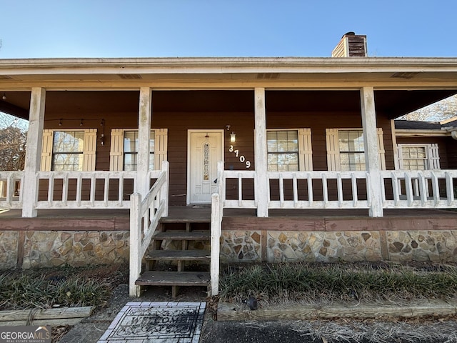 3709 Charlotte Dr, Rex, GA 30273 - property entrance with a porch and a chimney