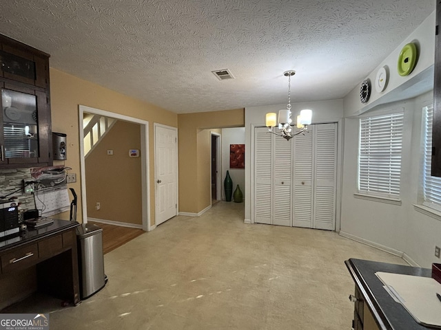 3709 Charlotte Dr, Rex, GA 30273 - dining room featuring a chandelier, baseboards, light flooring, plenty of natural light, and a textured ceiling