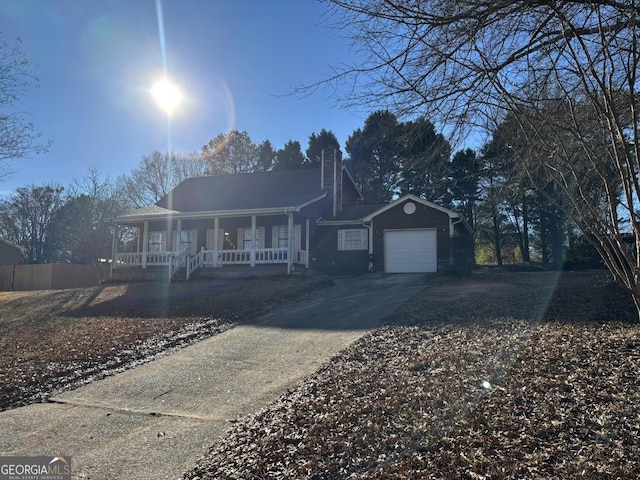 3709 Charlotte Dr, Rex, GA 30273 - view of front of property featuring covered porch, concrete driveway, an attached garage, a chimney, and fence