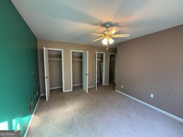 3709 Charlotte Dr, Rex, GA 30273 - unfurnished bedroom featuring carpet floors, baseboards, two closets, and ceiling fan