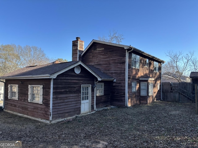 3709 Charlotte Dr, Rex, GA 30273 - back of property with a chimney and fence