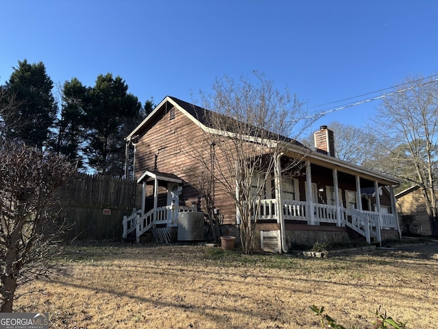 3709 Charlotte Dr, Rex, GA 30273 - view of side of property featuring covered porch, a chimney, and central AC unit