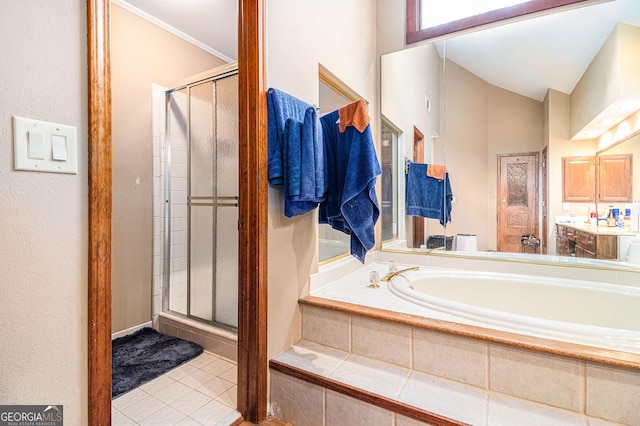 bathroom featuring a shower stall, a garden tub, tile patterned floors, and vanity