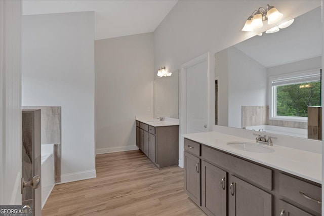 116 Daffodil Lndg, Dallas, GA 30132 - bathroom with a bath, wood finished floors, two vanities, and baseboards