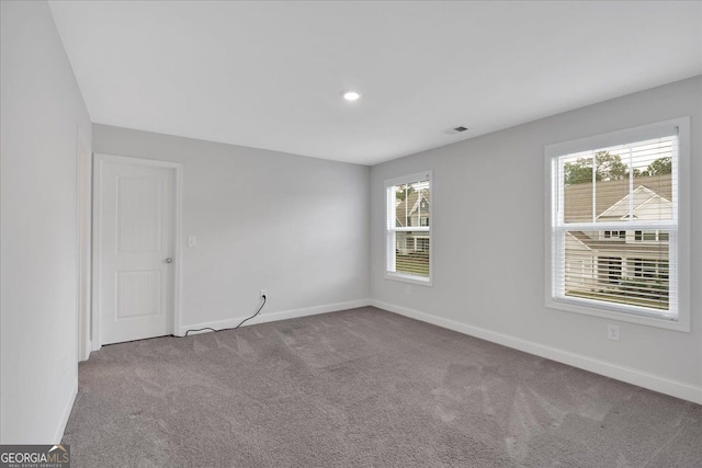 carpeted spare room with baseboards and recessed lighting