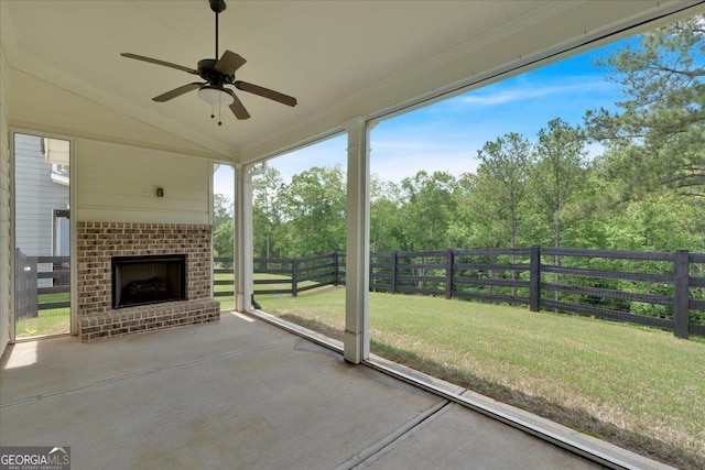 view of patio with a fireplace and a ceiling fan