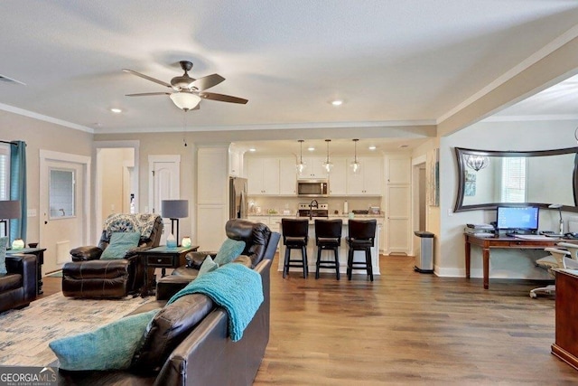 233 Isabella Way, Jesup, GA 31546 - living area with ornamental molding, a ceiling fan, wood finished floors, recessed lighting, and baseboards