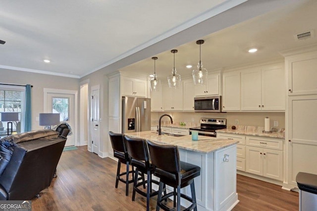 233 Isabella Way, Jesup, GA 31546 - kitchen with stainless steel appliances, a sink, white cabinets, dark wood-style floors, and light stone counters