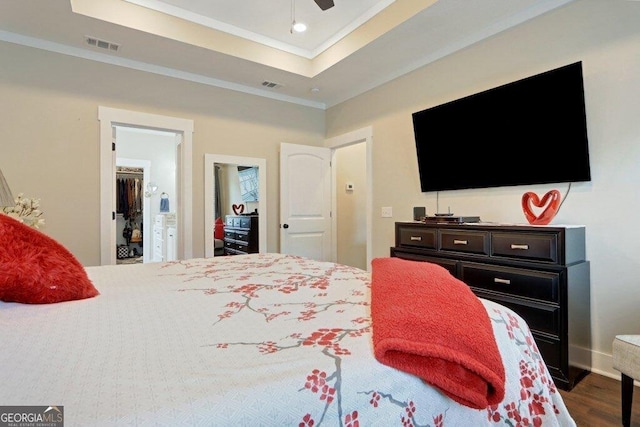 233 Isabella Way, Jesup, GA 31546 - bedroom with crown molding, wood finished floors, a walk in closet, a tray ceiling, and recessed lighting
