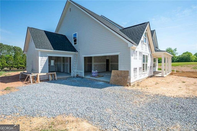 126 Telluride Trl NE, Calhoun, GA 30701 - back of house with a shingled roof and an attached garage