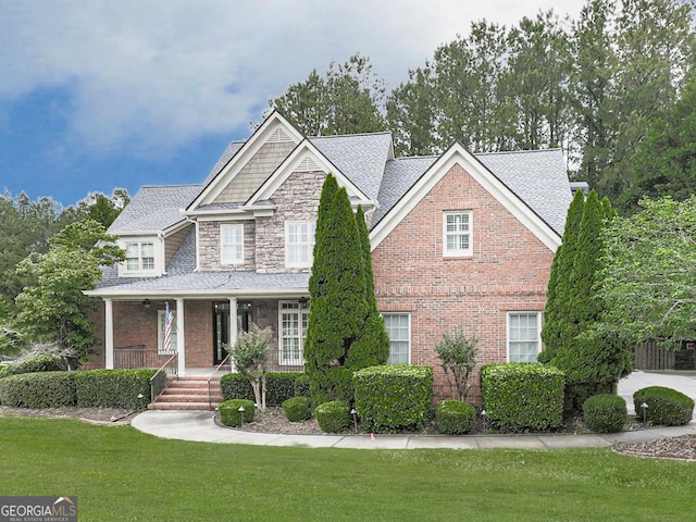 414 Candler Trl, Canton, GA 30115 - view of front of home featuring a porch, a front lawn, a shingled roof, and brick siding