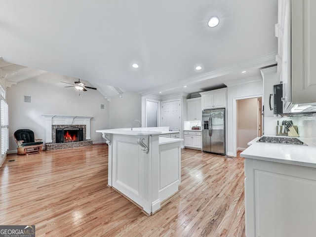 414 Candler Trl, Canton, GA 30115 - kitchen with stainless steel appliances, a ceiling fan, open floor plan, light countertops, and white cabinetry