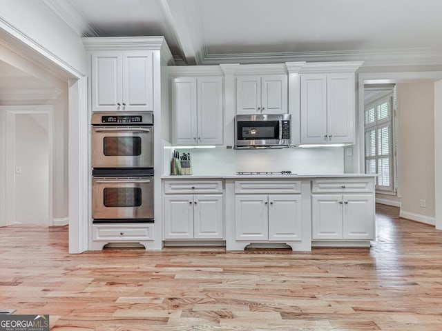 414 Candler Trl, Canton, GA 30115 - kitchen featuring stainless steel appliances, white cabinetry, ornamental molding, light wood-style flooring, and light countertops