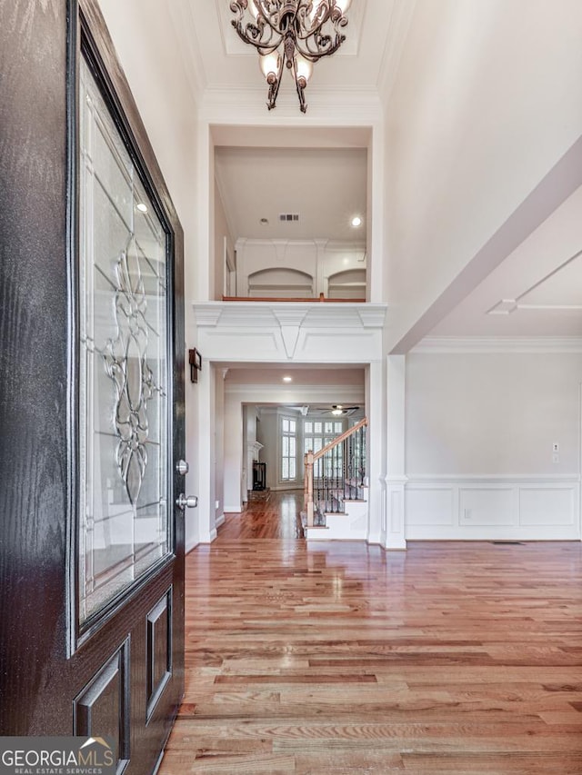 414 Candler Trl, Canton, GA 30115 - foyer featuring wood finished floors, crown molding, stairs, and a chandelier