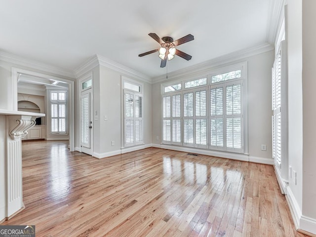 414 Candler Trl, Canton, GA 30115 - unfurnished living room with ceiling fan, light wood finished floors, healthy amount of natural light, and ornamental molding