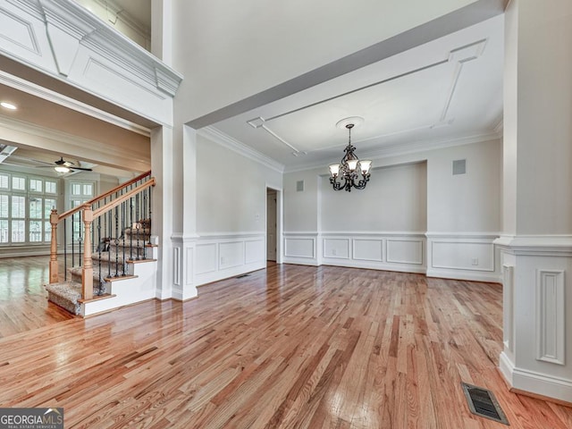 414 Candler Trl, Canton, GA 30115 - unfurnished living room with a chandelier, light wood-style floors, stairway, ornamental molding, and a ceiling fan