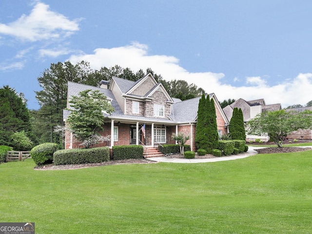 414 Candler Trl, Canton, GA 30115 - view of front of house featuring covered porch, a front yard, stone siding, and brick siding